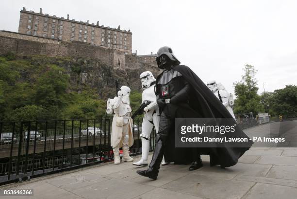Star Wars character Darth Vader with Stormtroopers and Snowtroopers at Edinburgh Castle ahead of a screening of Star Wars Episode V The Empire...