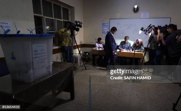 Kurdish officials prepare to open ballot boxes for counting votes after the close of polls during the referendum on independence at a polling station...