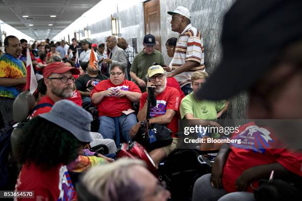 Disability rights group activists including members of ADAPT wait in line before a Senate Finance Committee hearing to consider the...