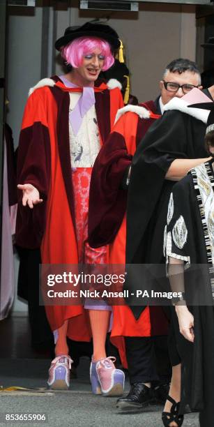 Artist Grayson Perry walks behind Lanvin designer Alber Elbaz as they make their way to the Royal Albert Hall to receive Honorary Doctorates from the...