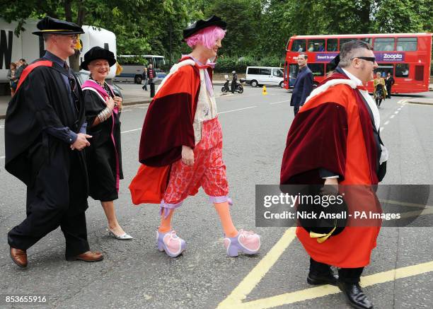 Artist Grayson Perry walks behind Lanvin fashion designer Alber Elbaz as they make their way to the Royal Albert Hall to receive Honorary Doctorates...