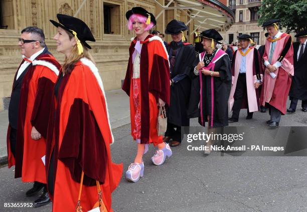 Artist Grayson Perry walks behind Lanvin fashion designer Alber Elbaz as they make their way to the Royal Albert Hall to receive Honorary Doctorates...
