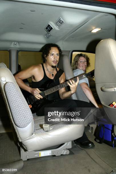 Photo of METALLICA; Kirk Hammett, playing guitar, warming up in SUV on the way to gig