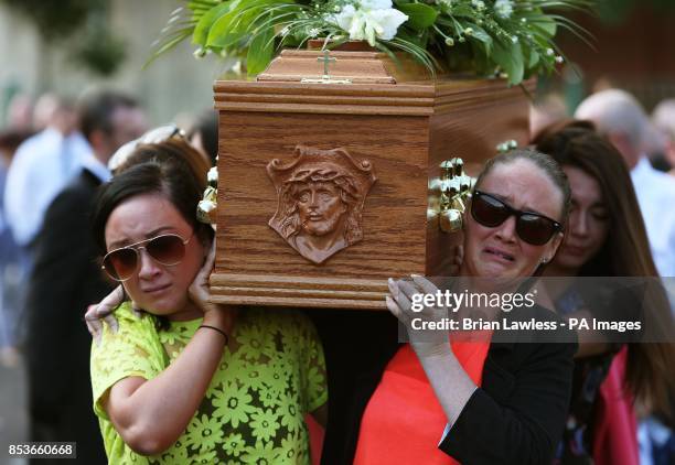 The coffin of Gerry Conlon, who was wrongly convicted of the 1974 IRA Guildford pub bombing, is carried to St Peter's Cathedral, Belfast, for his...