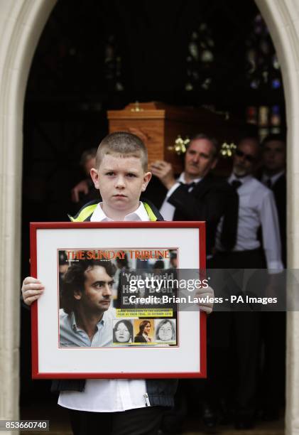 Grandnephew Padraig McKernan, aged 10, leads the coffin of Gerry Conlon, who was wrongly convicted of the 1974 IRA Guildford pub bombing, as it...