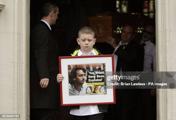 Grandnephew Padraig McKernan, aged 10, leads the coffin of Gerry Conlon, who was wrongly convicted of the 1974 IRA Guildford pub bombing, as it...