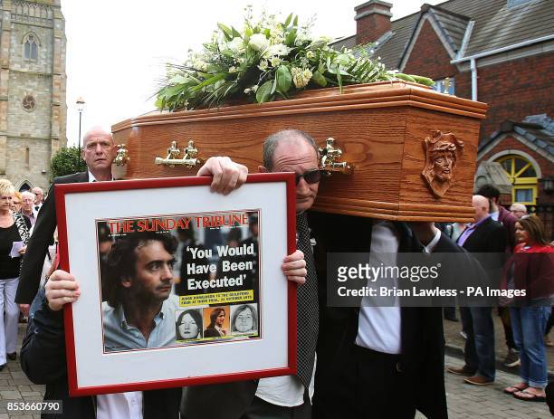 The coffin of Gerry Conlon, who was wrongly convicted of the 1974 IRA Guildford pub bombing, is carried from St Peter's Cathedral, Belfast, following...