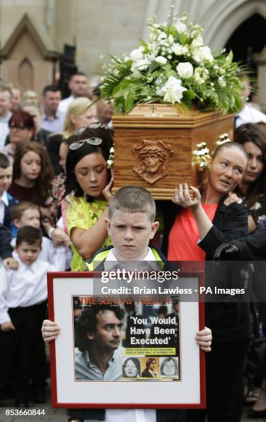 The coffin of Gerry Conlon, who was wrongly convicted of the 1974 IRA Guildford pub bombing, is carried from St Peter's Cathedral, Belfast, following...