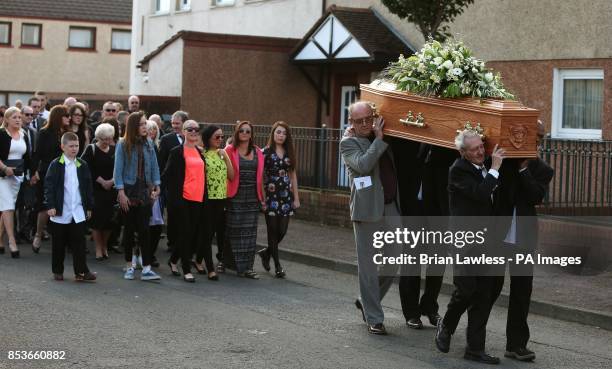 Birmingham Six member Paddy Hill carries the coffin of Gerry Conlon, who was wrongly convicted of the 1974 IRA Guildford pub bombing, from St Peter's...
