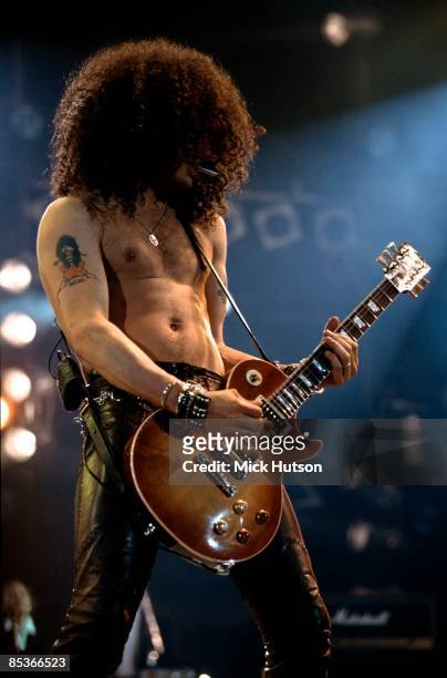 Photo of GUNS & ROSES and SLASH and GUNS N' ROSES and GUNS AND ROSES, Slash performing live onstage at the Freddie Mercury Tribute Concert, playing...