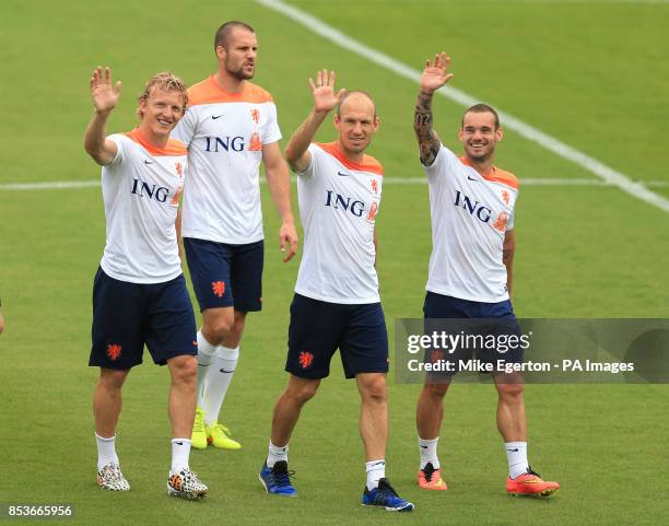 Holland's Dirk Kuyt, Ron Vlaas , Arjen Robben and Wesley Sneijder wave to their families during the training session at Estadio Jose Bastos Padilha,...