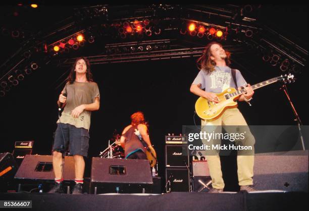 Photo of Jeff AMENT and PEARL JAM and Eddie VEDDER and Stone GOSSARD, L-R: Eddie Vedder, Jeff Ament, Stone Gossard performing live onstage