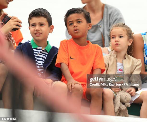 Patrick Kluivert's son Shane patrick sits between Robin van Persie's son Shaqueel and daughter Dina during the training session at Estadio Jose...