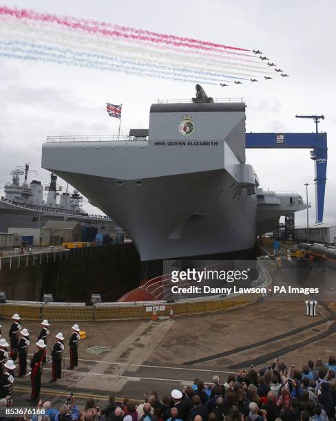 The Red Arrows fly over as Queen Elizabeth II officially names Royal Navy's new aircraft carrier HMS Queen Elizabeth during a visit to Rosyth...