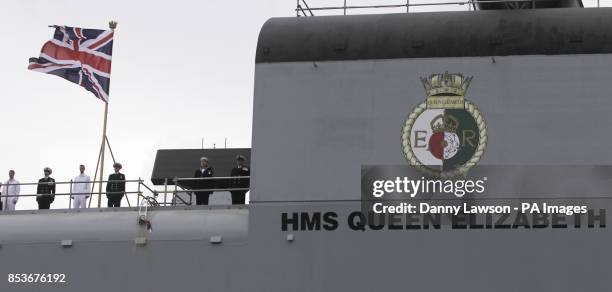 Bottle is smashed on the side of the Royal Navy's new aircraft carrier HMS Queen Elizabeth as Queen Elizabeth II officially named the ship during a...