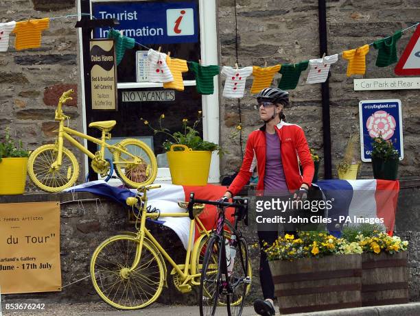 Sign shows No Vacancies at Dales Haven Bread and Breakfast as the bunting and knitted jerseys are displayed in Leyburn which is passed by the riders...