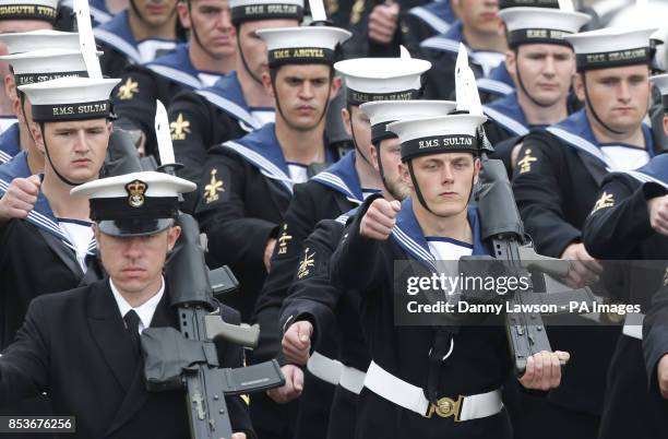 Members of he Royal Navy march as Queen Elizabeth II officially named Royal Navy's new aircraft carrier HMS Queen Elizabeth during a visit to Rosyth...