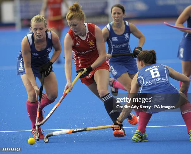 England's Nicola White runs through the Scottish defence Morag McLellan and Becky Ward during the Investec London Cup game at the Lee Valley Hockey...