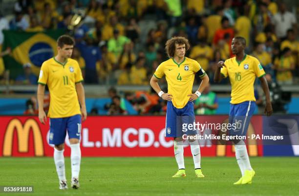 Brazil's Oscar, David Luiz and Ramires dejected during the FIFA World Cup Semi Final at Estadio Mineirao, Belo Horizonte, Brazil.