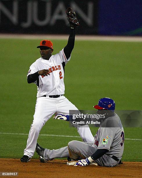 David Ortiz of the Dominican Republic slides safely into second base with a double as Yurendell de Caster of the Netherlands applies the tag during...