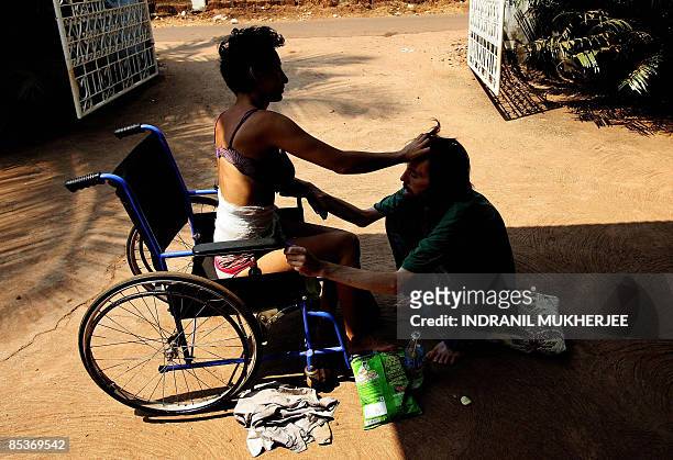 Lifestyle-India-tourism-health-addiction,FEATURE by Phil Hazlewood A psyhchiatric patient comforts a drug rehabilitation patient inside the premises...