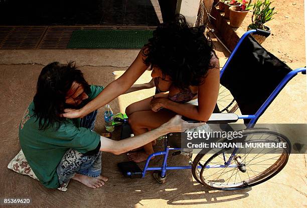 Lifestyle-India-tourism-health-addiction,FEATURE by Phil Hazlewood A psychiatric patient comforts a drug rehabilitation patient on the premises of...