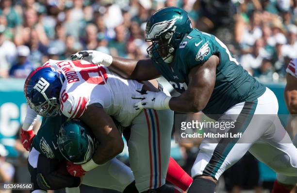 Jay Bromley of the New York Giants runs past Chance Warmack of the Philadelphia Eagles and sacks Carson Wentz in the first quarter at Lincoln...