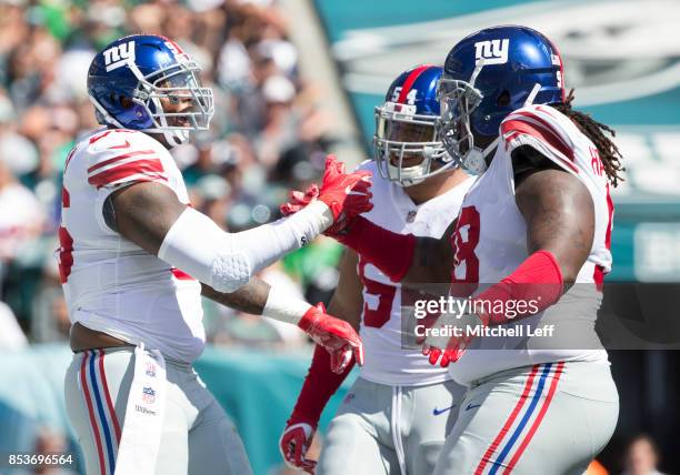 Jay Bromley of the New York Giants celebrates with Olivier Vernon and Damon Harrison against the Philadelphia Eagles at Lincoln Financial Field on...