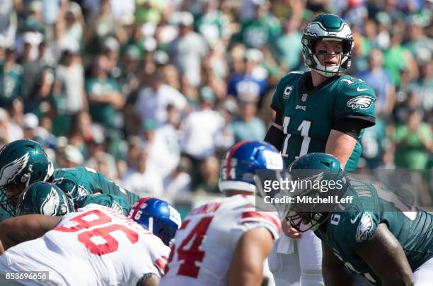 Carson Wentz of the Philadelphia Eagles looks on against Jay Bromley and Olivier Vernon of the New York Giants at Lincoln Financial Field on...