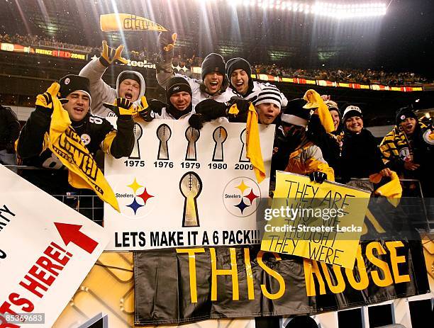 Fans of the Pittsburgh Steelers hold up signs in support of the Steelers after they won 23-14 against the Baltimore Ravens during the AFC...