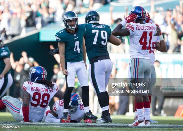 Jake Elliott of the Philadelphia Eagles celebrates in front of Damon Harrison, Robert Thomas, and Dominique Rodgers-Cromartie of the New York Giants...