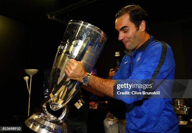 Roger Federer of Team Europe drinks champagne from Laver Cup trophy after winning the Laver Cup on the final day of the Laver cup on September 24,...