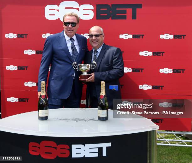 Harry Redknapp presents the trophy to trainer Richard Fahey after Heaven's Guest's victory in the 666bet Bunbury Cup