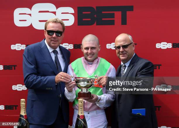 Harry Redknapp presents the trophy to jockey Tony Hamilton and trainer Richard Fahey after Heaven's Guest's victory in the 666bet Bunbury Cup