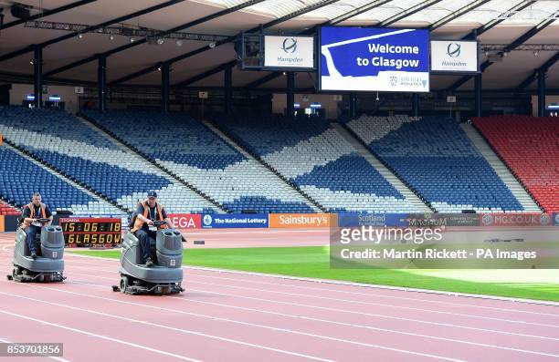 Workmen prepare the track at Hampden Park, Glasgow.
