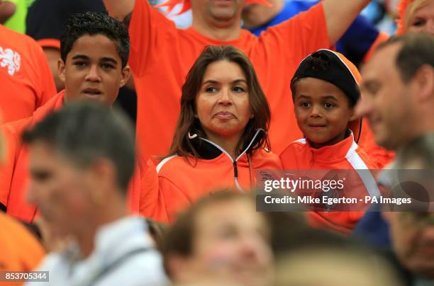 Wife of Netherlands assistant coach Patrick Kluivert Rossana Lima in the stands with son Shane Patrick