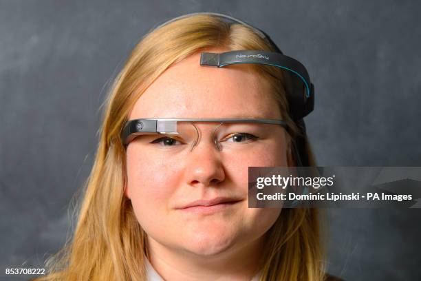 Chloe Kirton wearing Google Glass, and a Neurosky EEG biosensor, as a new MindRDR app enables people to control the wearable device using their mind.