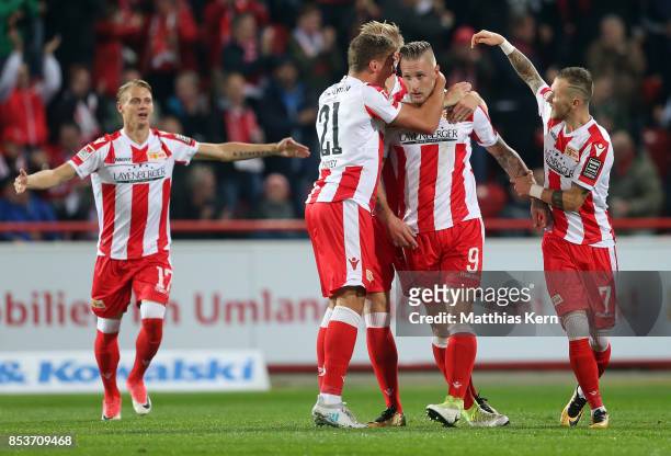 Sebastian Polter of Berlin jubilates with team mates after scoring the first goal during the Second Bundesliga match between 1. FC Union Berlin and...