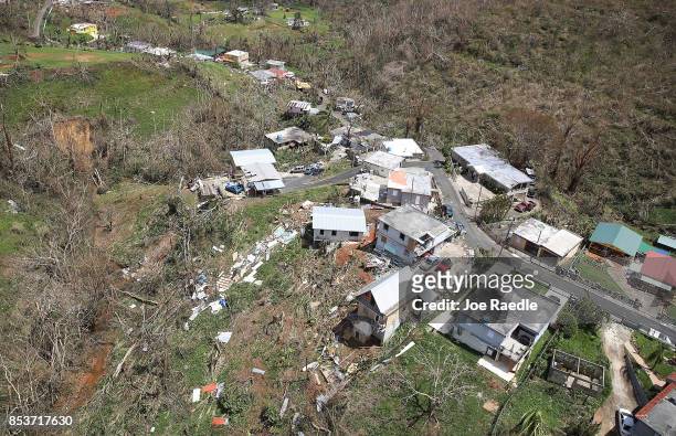 Damaged homes and downed trees are seen along a ridgeline as people deal with the aftermath of Hurricane Maria on September 25, 2017 in Corozal,...