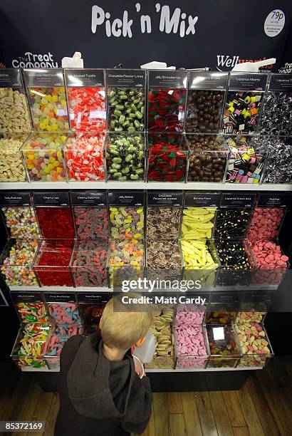 Small boy uses the Pick 'n' Mix inside the new Wellworths store on March 11 2009 in Dorchester, England. The radio and TV host invited himself down...