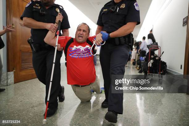 Capitol Police drag a blind protester out of a Senate Finance Committee hearing about the proposed Graham-Cassidy Healthcare Bill in the Dirksen...
