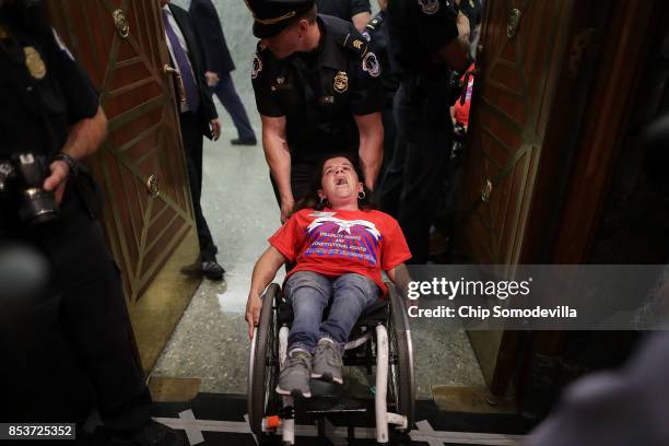 Capitol Police arrest protesters from handicap advocacy organizations as they shout and interrupt a Senate Finance Committee hearing about the...