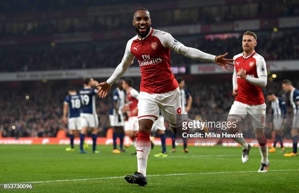 Alexandre Lacazette of Arsenal celebrates as he scores their first goal during the Premier League match between Arsenal and West Bromwich Albion at...