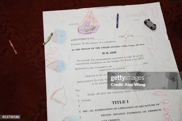 Children drawings are seen on an enlarged page one of the American Health Care Act of 2017 during a news conference on health care September 25, 2017...