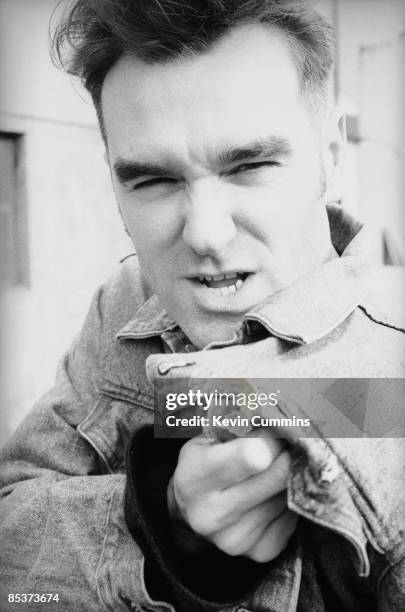 English singer and lyricist Morrissey in Dublin during his 'Kill Uncle' tour, April 1991. He is thrusting a union jack badge, in the shape of a map...