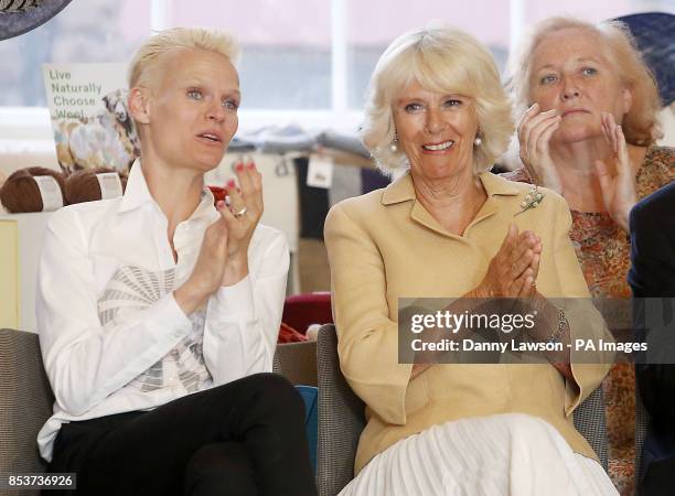 The Duchess of Cornwall with model Anna Freemantle as they watch a fashion show during a visit to the Edinburgh Fashion Festival at the Assembly...