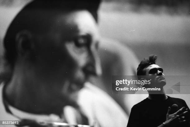 English singer and lyricist Morrissey on stage in Japan during his 'Kill Uncle' tour, September 1991. The backdrop is a portrait of poet Edith...