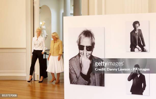 The Duchess of Cornwall with model Anna Freemantle as they view the work of photographer Rankin at his exhibition Portraits of Men during a visit to...