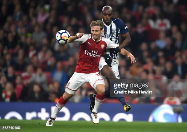 Allan Nyom of West Bromwich Albion and Nacho Monreal of Arsenal battle for the ball during the Premier League match between Arsenal and West Bromwich...
