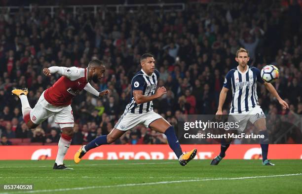 Alex Lacazette of Arsenal scores the opening goal during the Premier League match between Arsenal and West Bromwich Albion at Emirates Stadium on...
